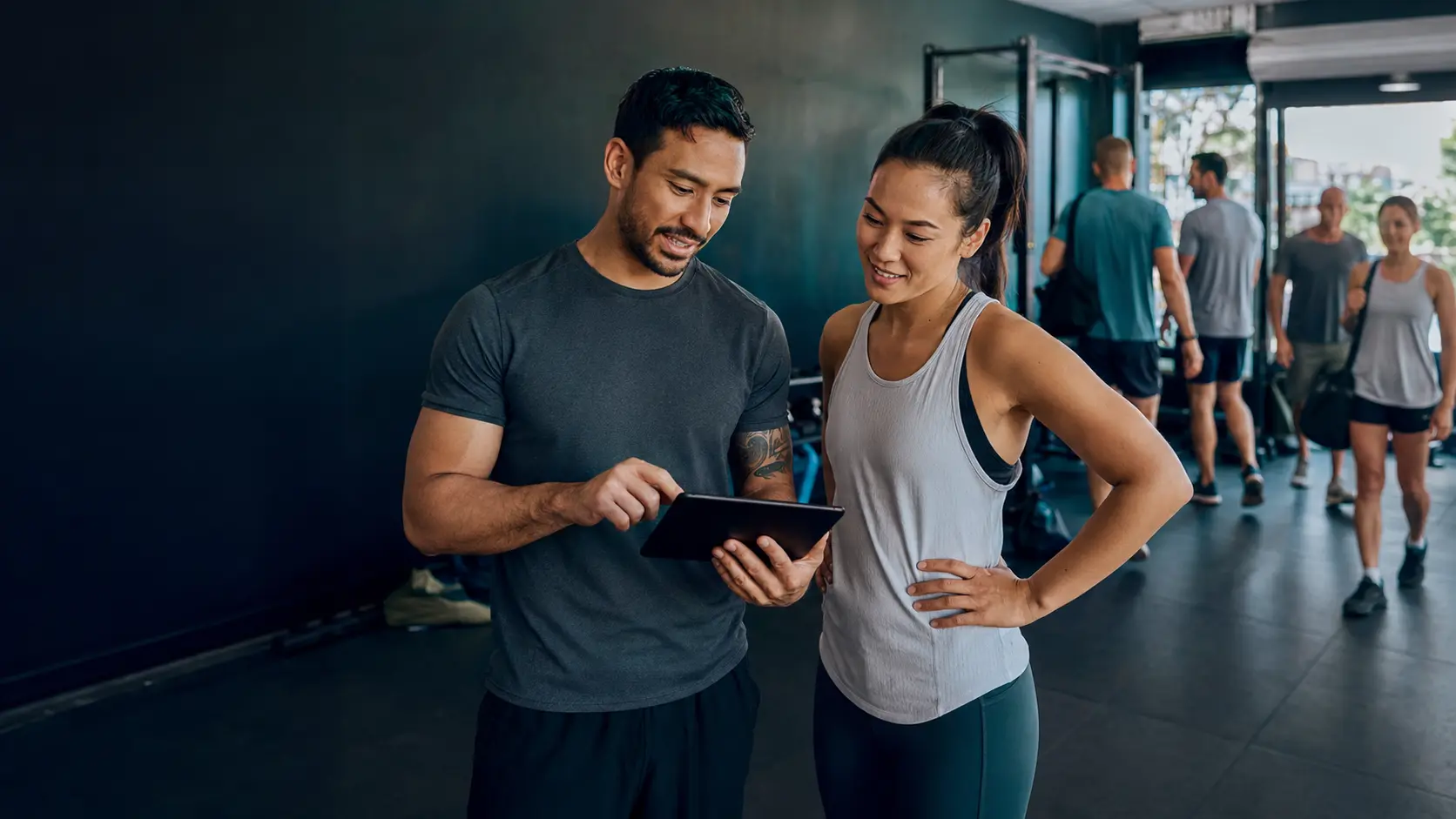A coach and member reviewing progress together in an owner-led academy